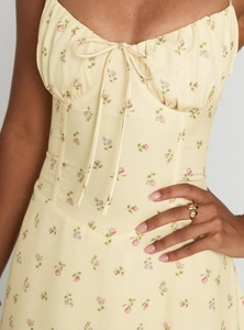 Close-up of yellow floral sundress with sweetheart neckline and drawstring detail