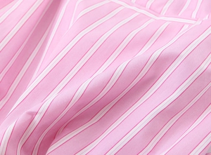 Close-up of pink and white striped cotton poplin fabric showing fine textile texture