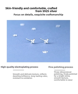 Macro shot of minimalist S925 sterling silver butterfly stud earrings with polished finish