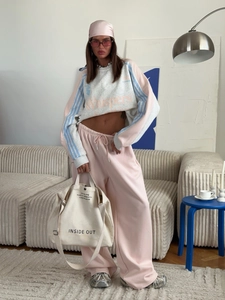 Detail of grey and pink sweatshirt set with drawstring pants and canvas tote bag