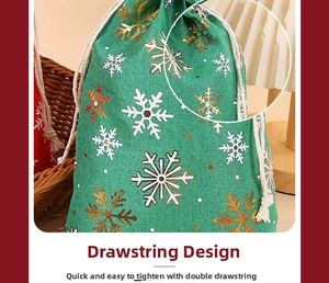 Detail of green burlap Christmas drawstring bag with gold and white snowflake patterns