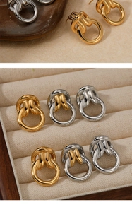 Detail of interlocking gold and silver double hoop earrings in a premium jewelry box