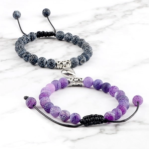Detail of couple bracelets with 8mm natural dragon vein stones and magnetic heart buckle