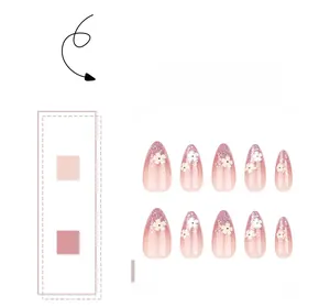Detail view of pink gradient almond press-on nails with silver glitter and white 3D flowers