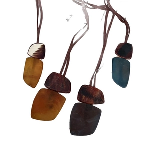 Set of four Bohemian necklaces with irregular square horn-style resin pendants on brown cords