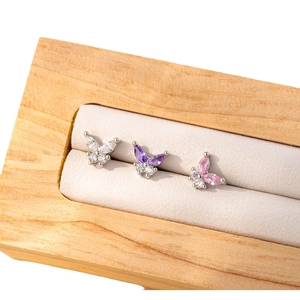 Mini zircon butterfly screw back earrings in white, purple and pink on a jewelry tray