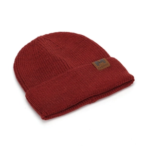 Detailed view of dark red knitted beanie with ribbed texture and brown fashion patch