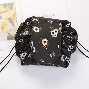 Detail of floral drawstring makeup bag with waterproof fabric and velcro closure flap