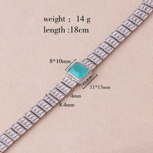 Detailed view of rectangular zircon bracelet with center green stone and size dimensions