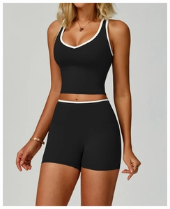 Gros plan d'un ensemble de sport noir avec bordures contrastées blanches et décolleté en V