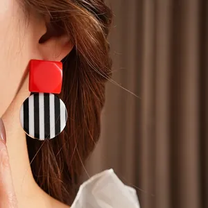 Vintage geometric earrings with red square and striped resin drops worn by model