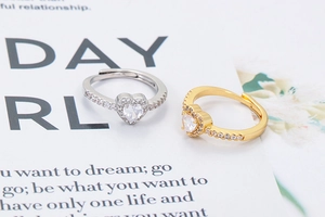 Two heart-shaped zircon rings in gold and silver plating with pavé-set crystals