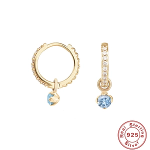 Elegant 925 sterling silver hoop earrings with gold plating and light blue round gemstones