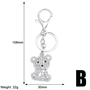 Detailed view of silver teddy bear keychain with iced out rhinestones and size measurements