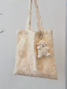 Off-white lace embroidery tote bag with floral patterns and a cute plush lamb charm