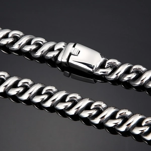Macro shot of silver hip hop chain necklace with box clasp on black background