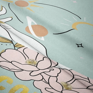 Close-up of soft velvet fabric featuring bohemian floral and cosmic celestial patterns