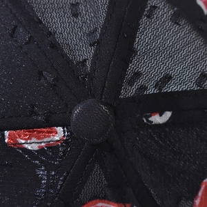 Close-up of the breathable mesh crown and top button of the floral pattern baseball cap