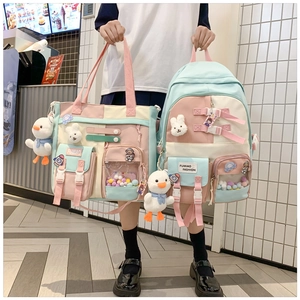 Detailed view of color-block school backpack with cute pendants and multi-pockets design