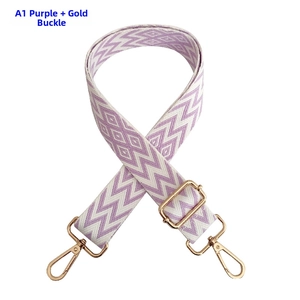 Close-up of adjustable purple zigzag guitar strap with golden metal lobster clasps