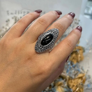 Close-up of vintage Bohemian ring featuring a large black gemstone and marcasite inlay