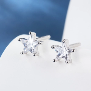 Macro shot of 925 silver star stud earrings with sparkling clear cubic zirconia stones