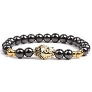 Natural stone bracelet with hematite beads and gold buddha head charm on white background