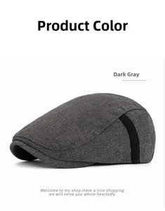 Detail of dark gray tweed ivy cap showing side black strap and metal eyelet accents