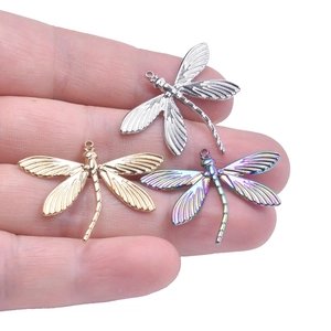 Detailed view of dragonfly pendants in gold, silver and rainbow finish for DIY jewelry