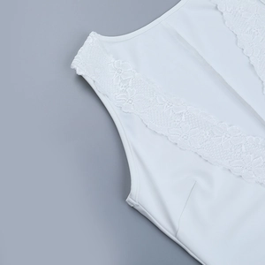 Close-up of white yoga jumpsuit featuring delicate floral lace trim and premium plain fabric