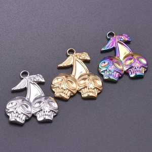 Detailed view of cherry skull pendants in gold, silver, and rainbow stainless steel