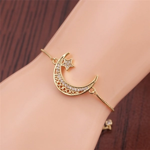 Close-up of adjustable gold star and moon bracelet with sparkling zircon stones