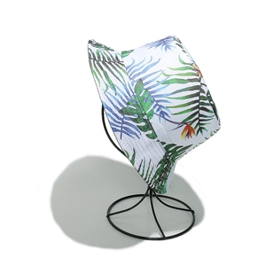 Detail of tropical palm leaf and bird of paradise print on cotton canvas bucket hat