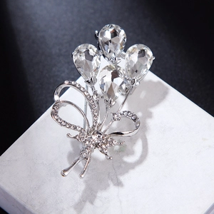 Elegant silver balloon bouquet brooch with clear zircons on a white display cube