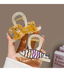 Detail of cute cartoon poodle and colorful fish hair claws made of acetate material