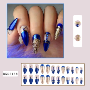 Detailed view of long almond fake nails with blue rhinestones and gold line designs