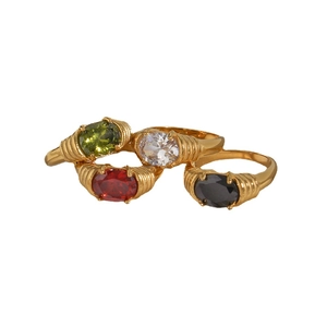Stack of gold stainless steel rings with oval zircons in green, clear, red, and black