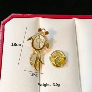 Golden dolphin brooch with transparent gems and dimensions of 3.0cm by 1.6cm