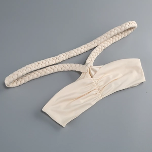 Detailed view of cream off-shoulder bikini top with elegant beaded halter straps and silk texture