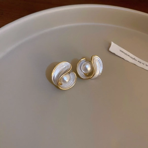Vintage gold swirl earrings with white enamel and centered pearl in classic palace style