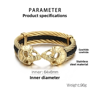 Detail view of gold stainless steel skull bracelet with black braided leather inlay