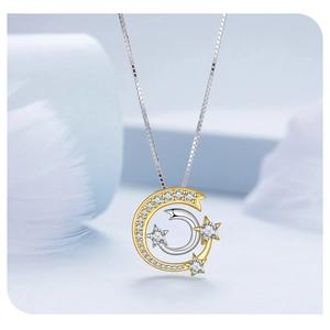 Detailed close-up of a s925 silver moon and star pendant with sparkling zircon inlays