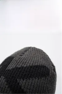 Close-up of the thick knit texture and two-tone grey stitching on the winter beanie