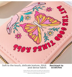 Close-up of pink PU leather coin purse with vintage butterfly floral print and zip closure