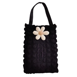 Detail of black bubble texture car tissue holder with 3D cream flower ornament
