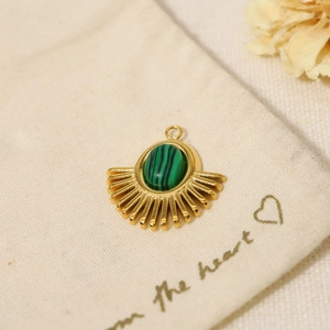 Detail of bohemian gold stainless steel pendant with green malachite stone inlay