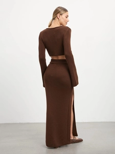Detail of brown ribbed knit two-piece set featuring long sleeves and high side slit skirt