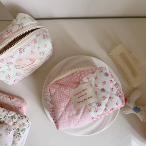 Pink floral quilted toast makeup bag with checkered patterns and french label embroidery