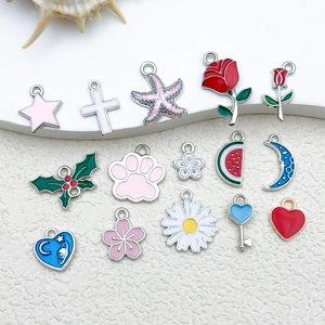 Detailed assortment of colorful enamel charms featuring starfish and leaf designs for jewelry