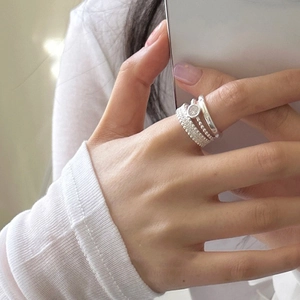 Minimalist silver stacked rings set featuring textured bands and beads for modern women